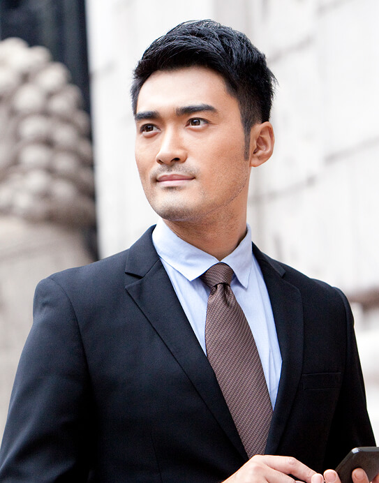 Businessman with smart phone outside a b ZKQG96T